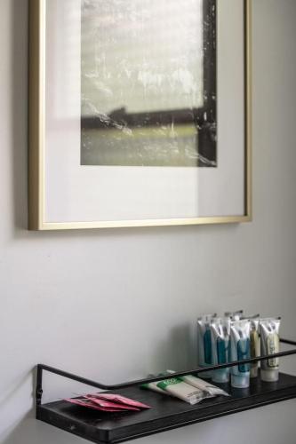 a black shelf with a picture on a wall at Lumberjill Lodge 12 King Room in Balsam Lake