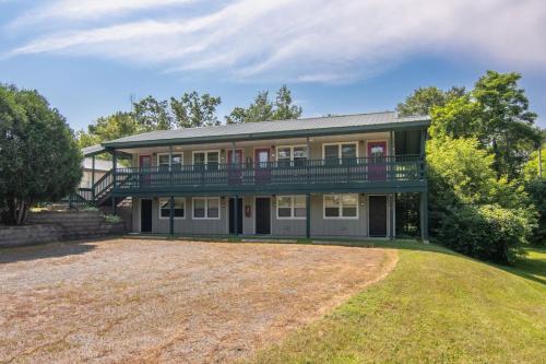 a large house with a balcony and a yard at Lumberjill Lodge 12 King Room in Balsam Lake