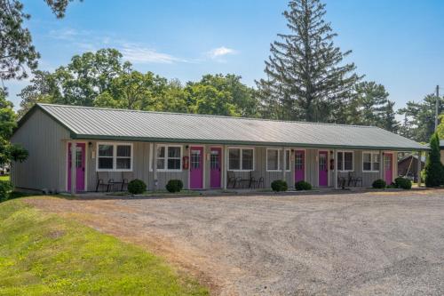 a building with pink and purple doors at Lumberjill Lodge 11 King Room in Balsam Lake