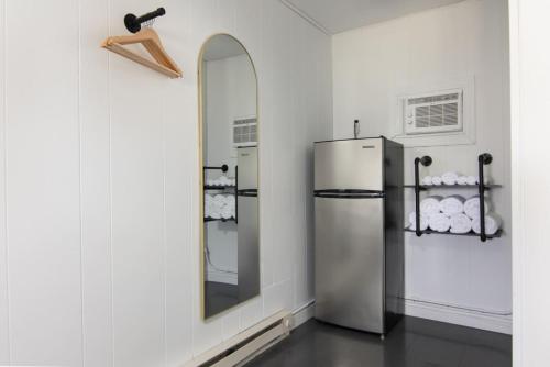 a kitchen with a refrigerator and a mirror at Lumberjill Lodge 13 Double Queen Room in Balsam Lake