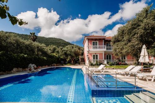 a villa with a swimming pool and a house at Kyprianos in Keri