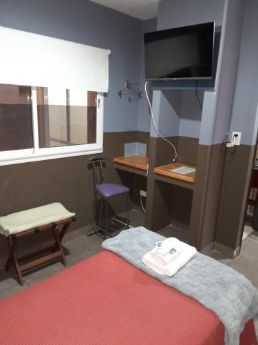 Giường trong phòng chung tại Hotel Leguizamón