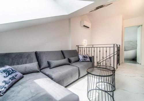 a living room with a couch and a table at Luxury Apartment Queens on two floors with a panoramic sea view in Dramalj