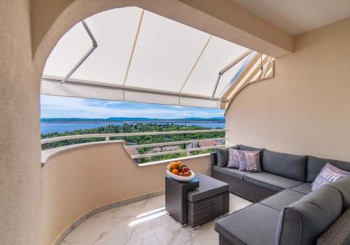 a living room with a couch and a large window at Luxury Apartment Queens on two floors with a panoramic sea view in Dramalj