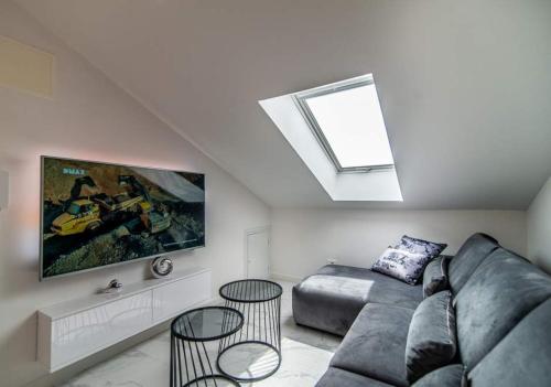 a living room with a couch and a skylight at Luxury Apartment Queens on two floors with a panoramic sea view in Dramalj