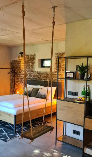 a bedroom with a swinging bed in a room at 1Step2AllNature Tinyhouse in Wuppertal