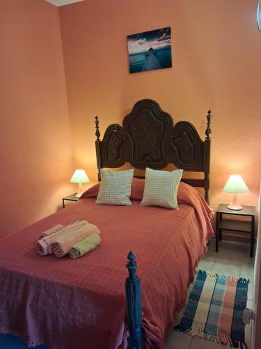 a bedroom with a large bed with two pillows at Casa laranja in Albufeira