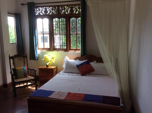 a bedroom with a bed and a window at HELFAROAN Spacious, Superb panoramic view! in Kandy