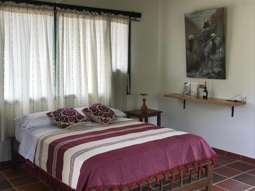 a bedroom with a bed and a window at Santa Lucia Estancia Rural in Guaduas