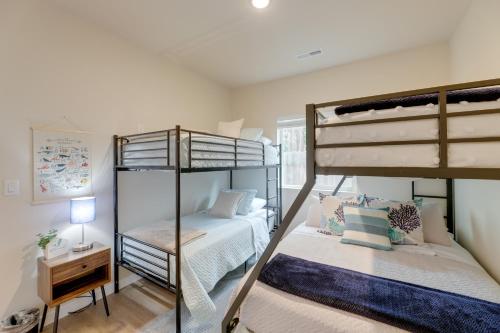 a bedroom with two bunk beds and a desk at Family-Friendly Florence Home 3 Mi to the Coast! in Florence