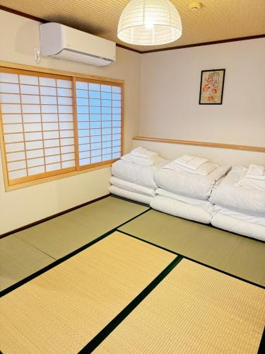 a room with two beds on the floor at Ikoi no Ie - Vacation STAY 61490v in Kyoto