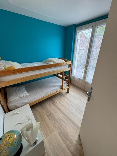 Ένα ή περισσότερα κρεβάτια σε δωμάτιο στο Maison de vacances ile d'Oléron