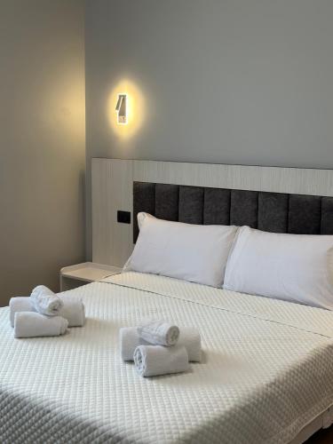 a bedroom with a bed with towels on it at Hotel Garden in Rivoli