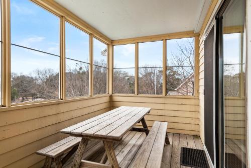 a wooden bench in a room with windows at A Shore Thing in Duck in Duck