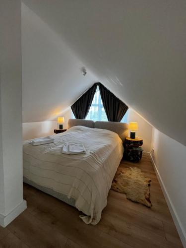 a bedroom with a bed and a large window at Girios Horizontas - Mara in Trakai