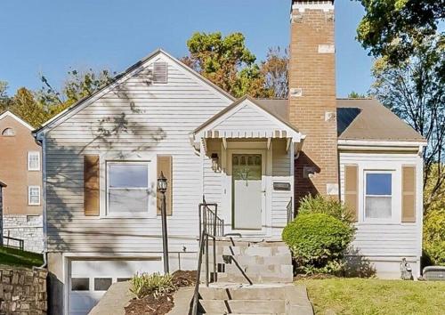a white house with a brick chimney at Stylish 3BR with Patio Walk to State Capitol in Frankfort