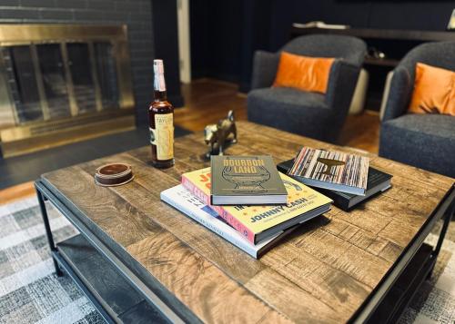 a bottle of wine and books on a coffee table at Stylish 3BR with Patio Walk to State Capitol in Frankfort