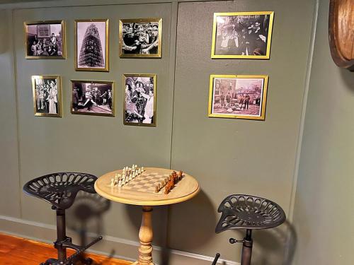 a room with a table and two chairs and pictures on the wall at Stylish 3BR with Patio Walk to State Capitol in Frankfort