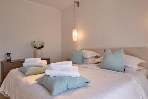 a bedroom with two beds with blue and white pillows at Afroditi Arhontiko in Litochoro