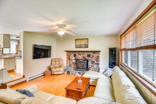 a living room with a couch and a fireplace at 6 Mi to Beach Family Home in Little Compton! in Little Compton