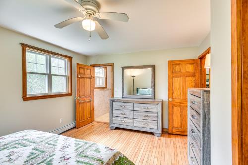 a bedroom with a bed and a dresser and a mirror at 6 Mi to Beach Family Home in Little Compton! in Little Compton
