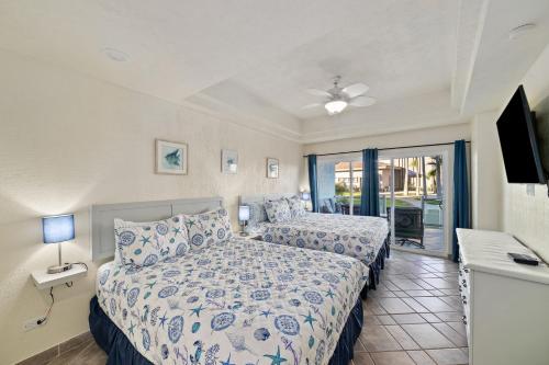 a bedroom with two beds and a balcony at Las Palmas 2BR 2BA Suite Ground Floor- D101 in Campo del Medio