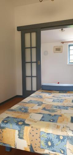 a bedroom with a bed with a quilt on it at Karsolina in Štanjel