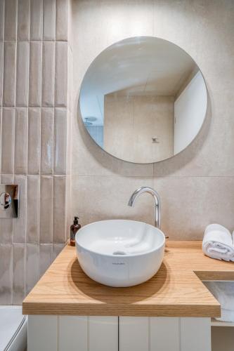 a bathroom with a white sink and a mirror at PALELIA living in the olive garden in Nafplio