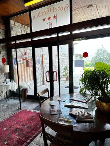 a dining room with a table and a large window at Hotel Garden in Rivoli