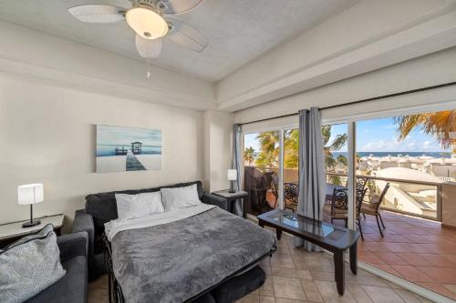 a bedroom with a bed and a view of the ocean at Las Palmas 2BR 2BA Suite 3rd FL Ocean View- B301 in Campo del Medio