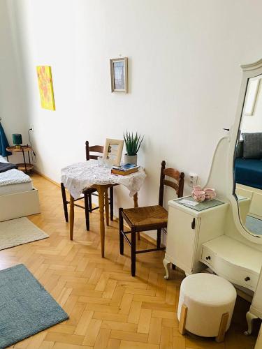 a living room with a table and chairs and a sewing machine at Hostel Moravia Ostrava in Ostrava