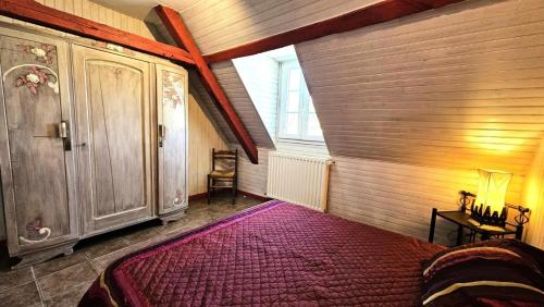 a bedroom with a large red bed in a room at Gîte de France "les volets bleus" 3 épis - Gîte de France 12 personnes MAE-9484 in Espartignac