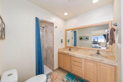 a bathroom with a sink and a toilet and a mirror at Las Palmas 2BR 2BA Suite 2nd FL Ocean View- G205 in Campo del Medio
