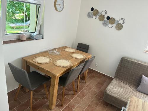 a dining room with a wooden table and chairs at Chata na soutoku in Kestřany