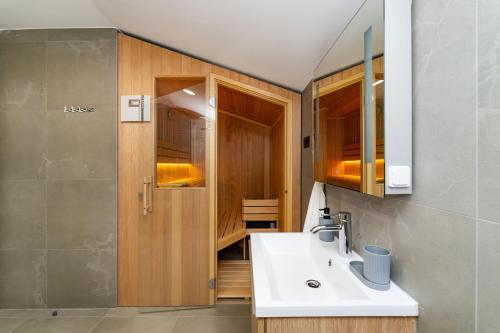 a bathroom with a sink and a shower at MY DALMATIA - Villa Campi Dalmatia with private heated pool and sauna in Galovac