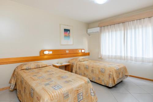 Ένα ή περισσότερα κρεβάτια σε δωμάτιο στο Hotel Suárez Campo Bom