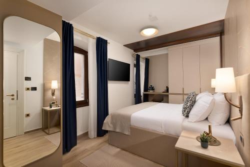 Cama o camas de una habitación en H - Suites