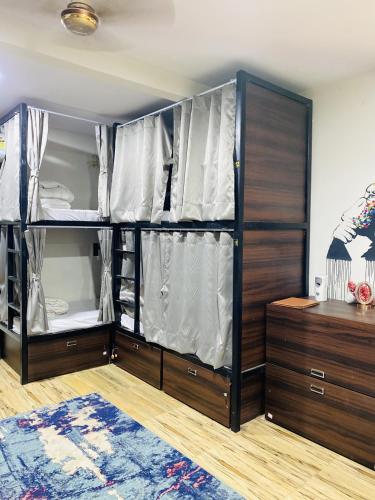 a bedroom with wooden bunk beds and a large closet at The Commune Banaras in Varanasi