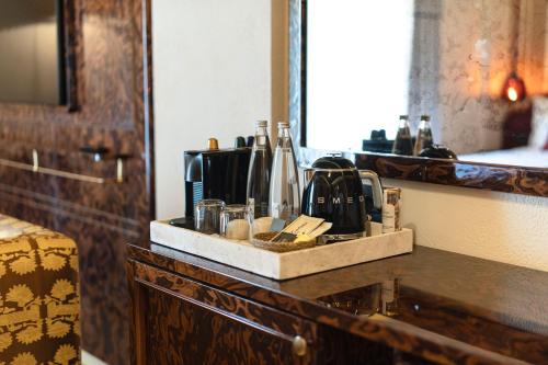 a counter top with a tray with bottles on it at Casa Fontana in Alacati