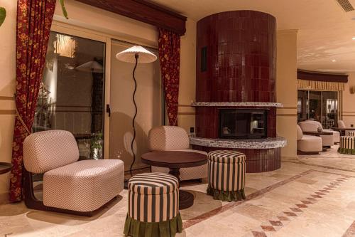 a lobby with a fireplace and a table and chairs at Casa Fontana in Alacati