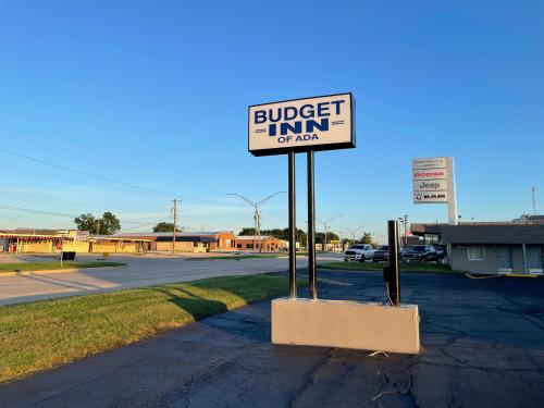 a sign for a burger inn on a street at Budget Inn Ada in Ada