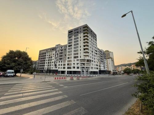 a large white building on the side of a street at Stupine Gold in Tuzla