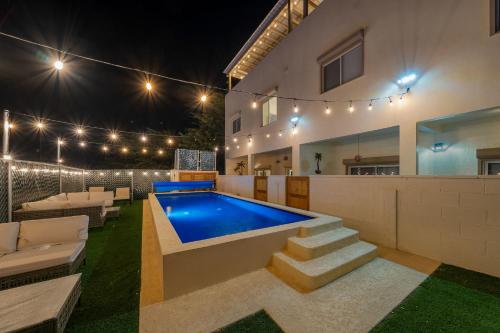 a swimming pool in the backyard of a house at night at 3 Story House 3BR 2BA Rooftop View with Heated Pool in La Choya