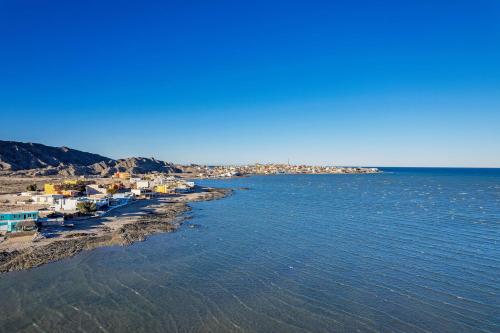 an aerial view of a beach with houses and the water at 3 Story House 3BR 2BA Rooftop View with Heated Pool in La Choya