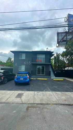 a blue car parked in front of a building at Wynwood Bungalows By Renzzi in Miami