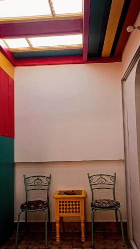two chairs and a table in a room at Riad SULTANA lateral seaview in Saidia 