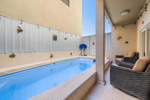 a swimming pool in the middle of a house at 3 Story Home 3BR 2BA with Pool Garage and Rooftop View in La Choya