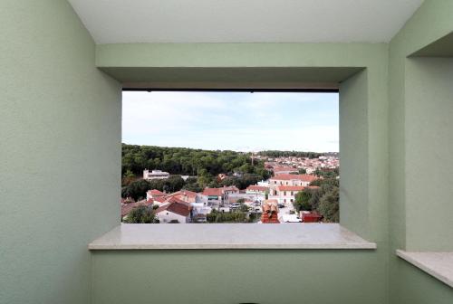 a view of a city from a window in a building at Arena Prestige Rooms in Pula