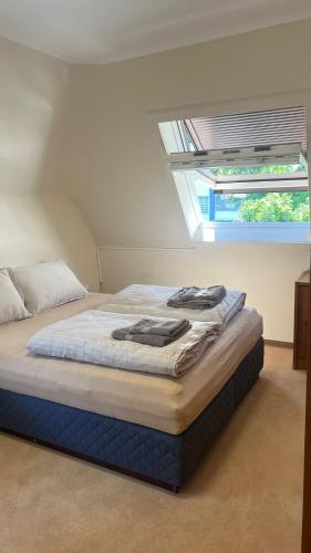 a bed with two towels on it in a bedroom at Marlin City Apartment 2 in Bielefeld