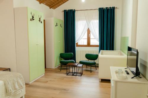 a bedroom with green accents and a bed and a tub at Cerma Bucovina in Marginea